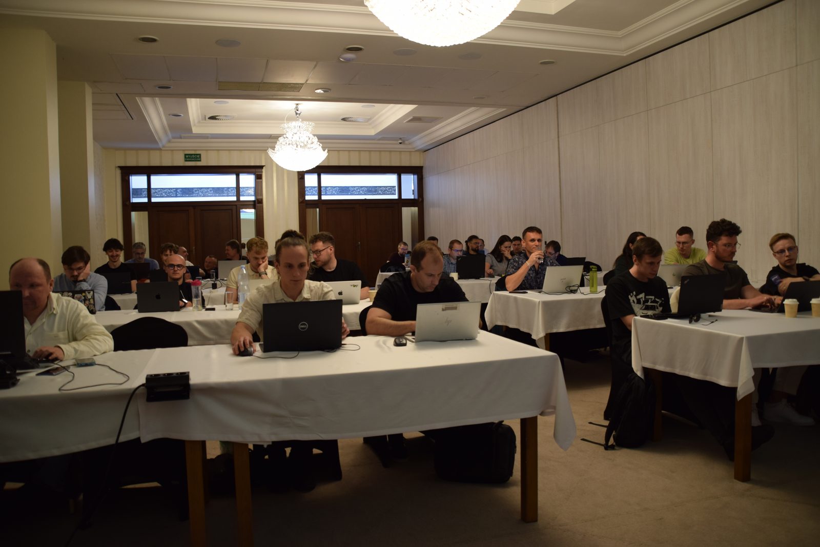 Workshop participants at tables with laptops