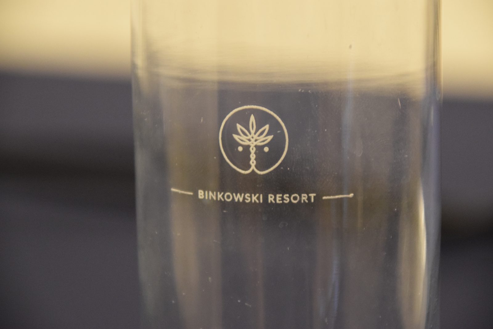 A glass with the Binkowski Resort logo